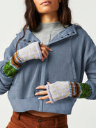 Woman wearing a Sahara Sky Hooded Jacket with a zip-up front, textured waffle knit, and button detailing in blue and brown tones.