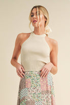 A high-neck tank top named "Nora".A high-neck tank top named "Nora".
