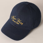 Beige and navy New York Social Club embroidered baseball caps with curved brims.