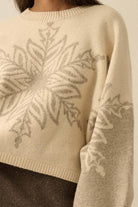 Oversized cream sweater with grey snowflake design.