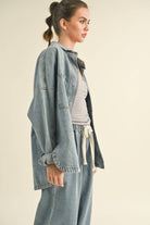 Model in an oversized denim jacket with front pockets. First image: jacket buttoned, paired with white shorts. Second image: jacket open, over a grey tank and denim pants.