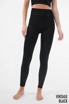 Woman wearing Serenity High-Waist Ribbed Leggings in vintage cool grey, featuring a high-rise waistband and ribbed texture for a sleek, supportive fit.