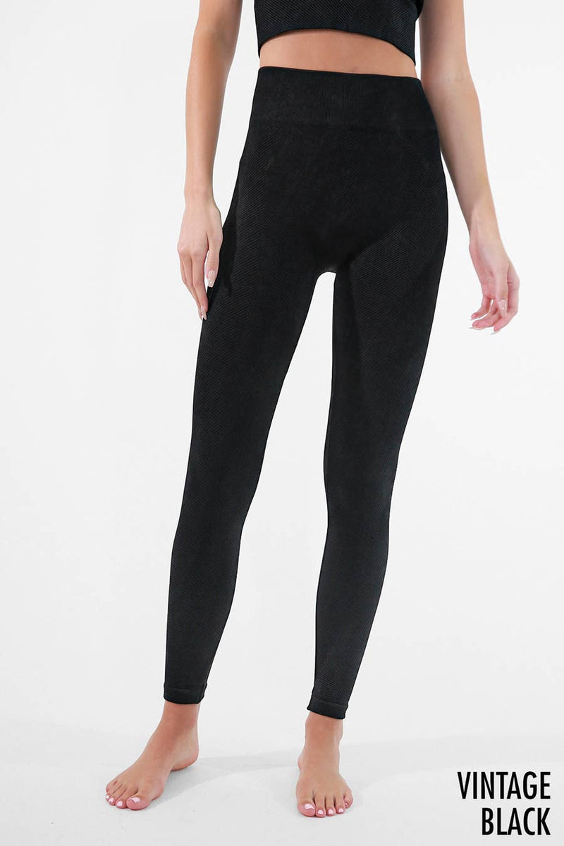 Woman wearing Serenity High-Waist Ribbed Leggings in vintage cool grey, featuring a high-rise waistband and ribbed texture for a sleek, supportive fit.