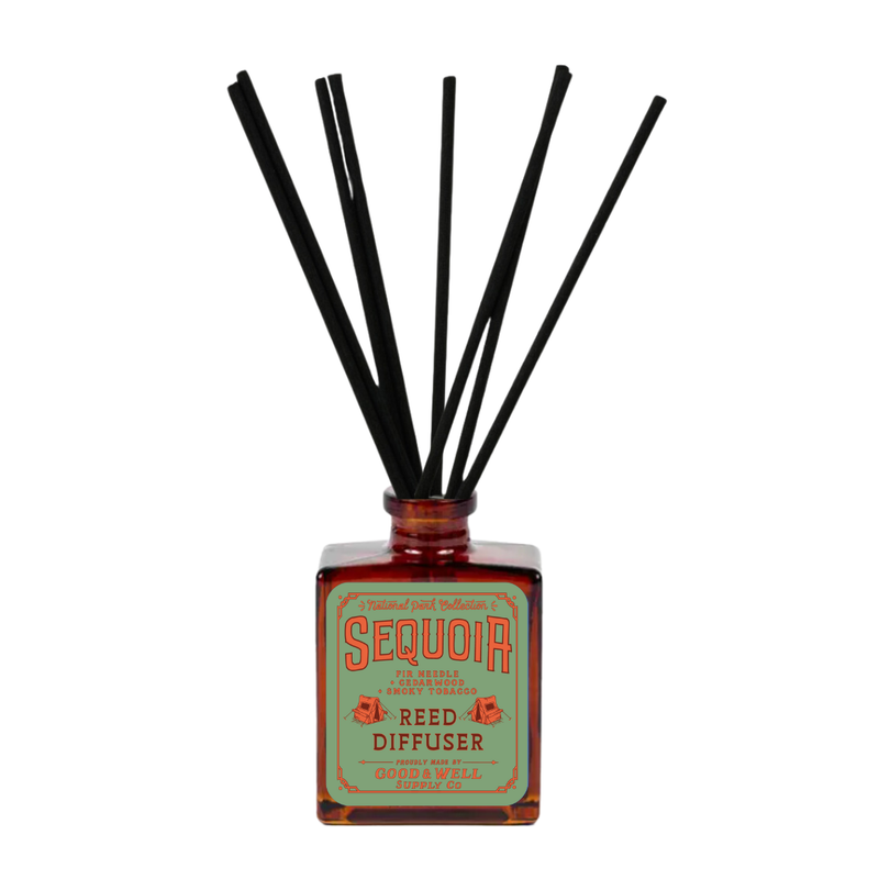 Hawai‘i Volcanoes reed diffuser with amber bottle and black reeds by Good & Well Supply Co., featuring wild fig, ginger, and citrus.