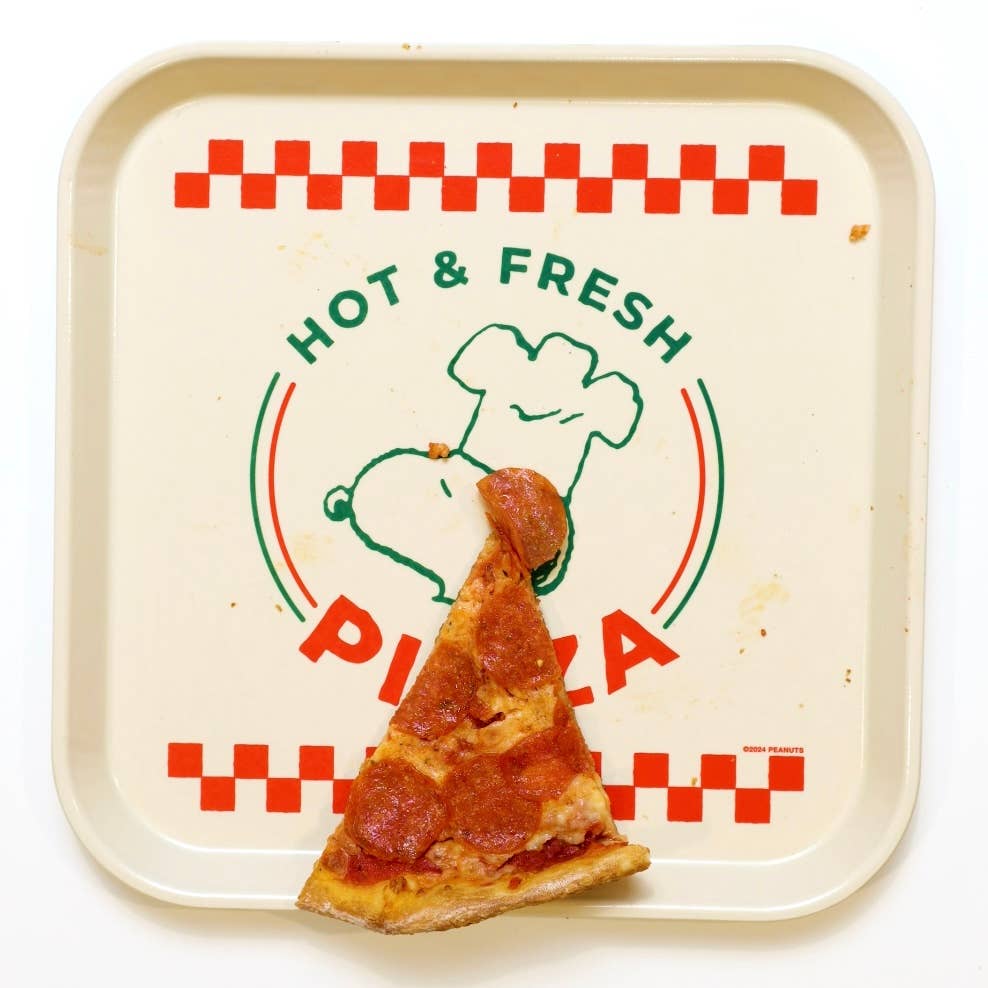 Square cream-colored tray with a green outline of Snoopy wearing a chef’s hat, red checkered accents, and the words “Hot & Fresh Pizza.”
