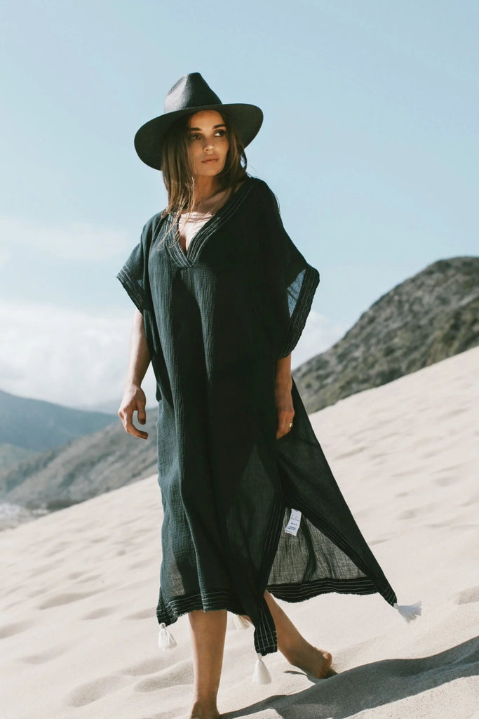 Woman gracefully wearing the Ela Kaftan with a relaxed silhouette, V-neckline, and wide sleeves, showcasing its elegance and comfort.