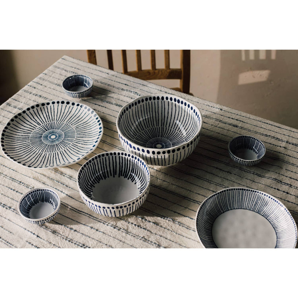 Sprout Stamped Plate with intricate blue radial patterns and an organic shape, ideal for serving and display.
