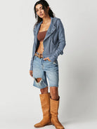 Woman wearing a Sahara Sky Hooded Jacket with a zip-up front, textured waffle knit, and button detailing in blue and brown tones.