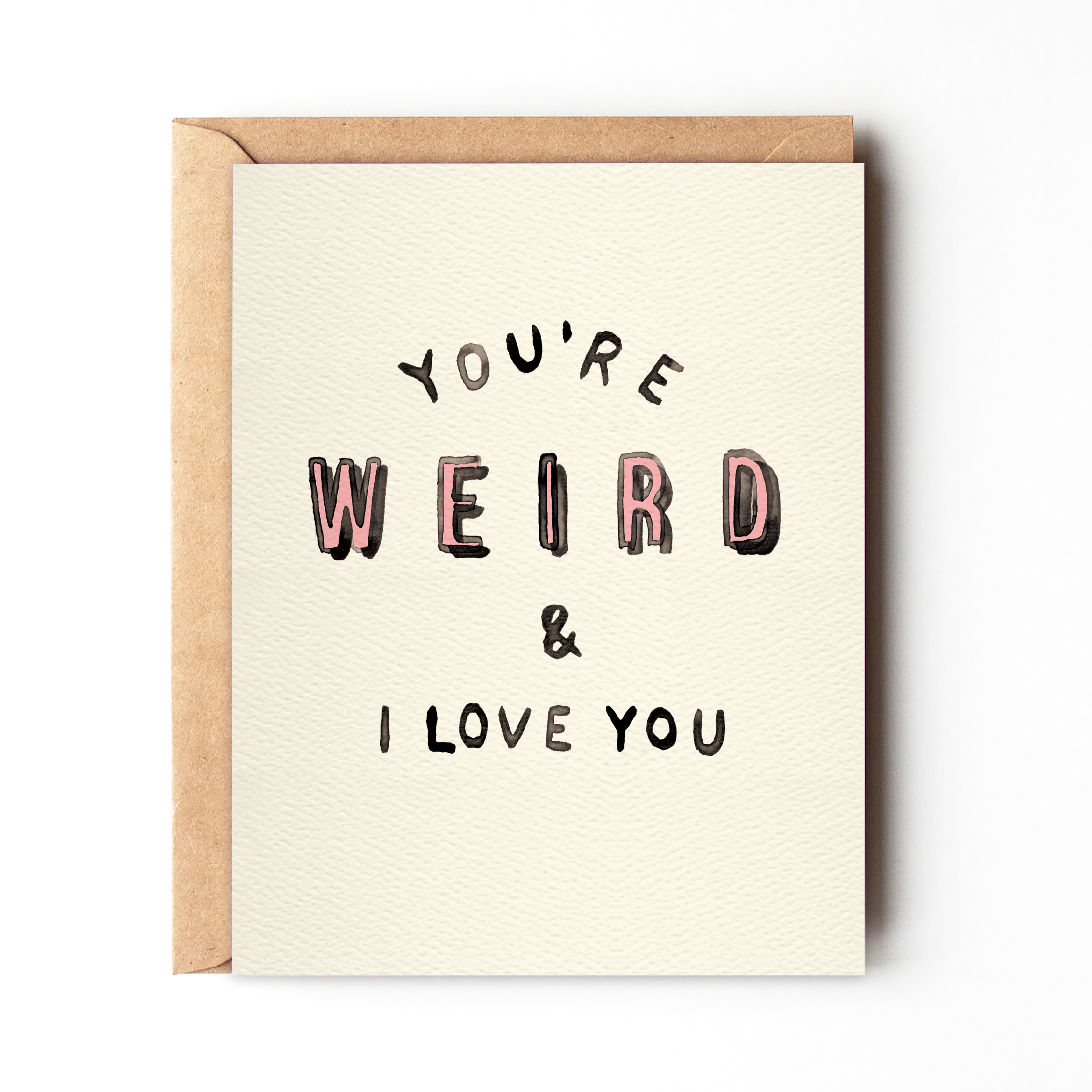 Off-white card with black and pink text saying ‘You’re Weird & I Love You,’ presented with a brown envelope.