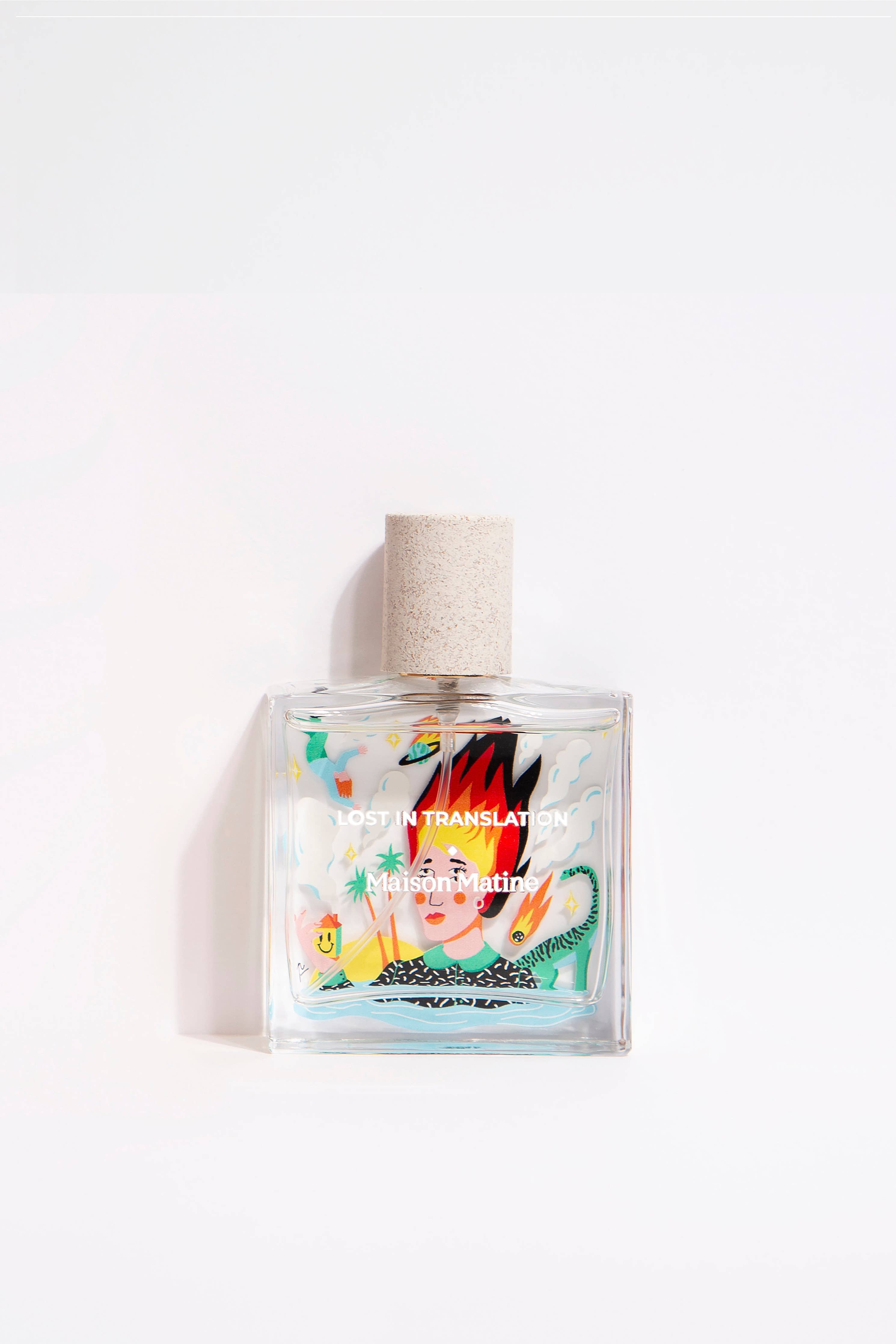 Maison Matine Lost in Translation perfume bottle with bold illustrated design, placed on vibrant yellow textured surface.