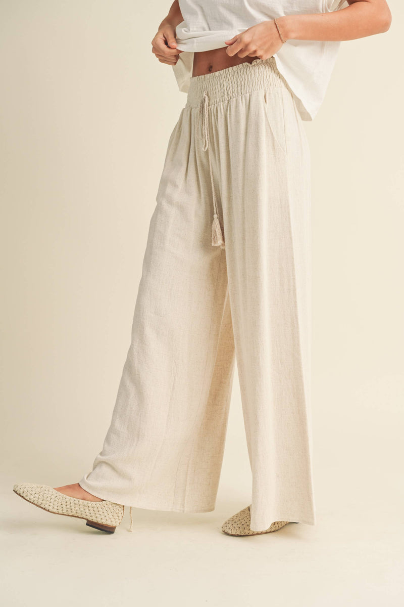 Wide-leg cotton-linen pants with smocked waistband and tassel drawstring