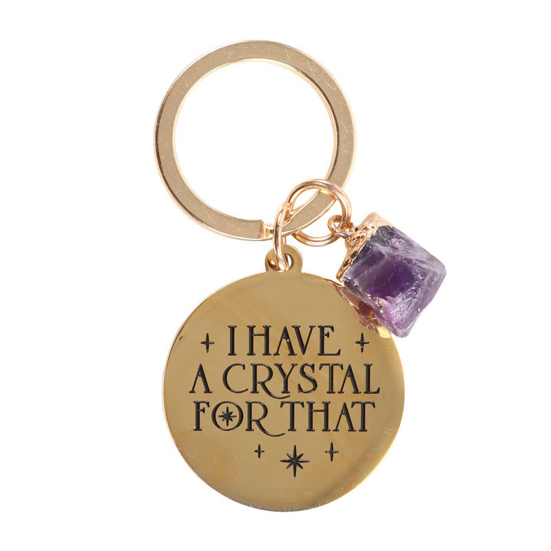 Gold-tone keychain with a medallion engraved “I Have A Crystal For That” and a genuine amethyst crystal charm.