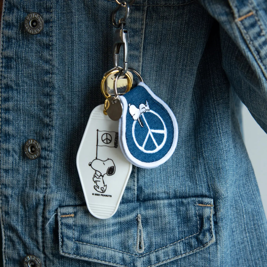 Peanuts Snoopy Peace Patch Keychain - Snoopy promoting peace. A stylish and meaningful accessory for keys or bags.