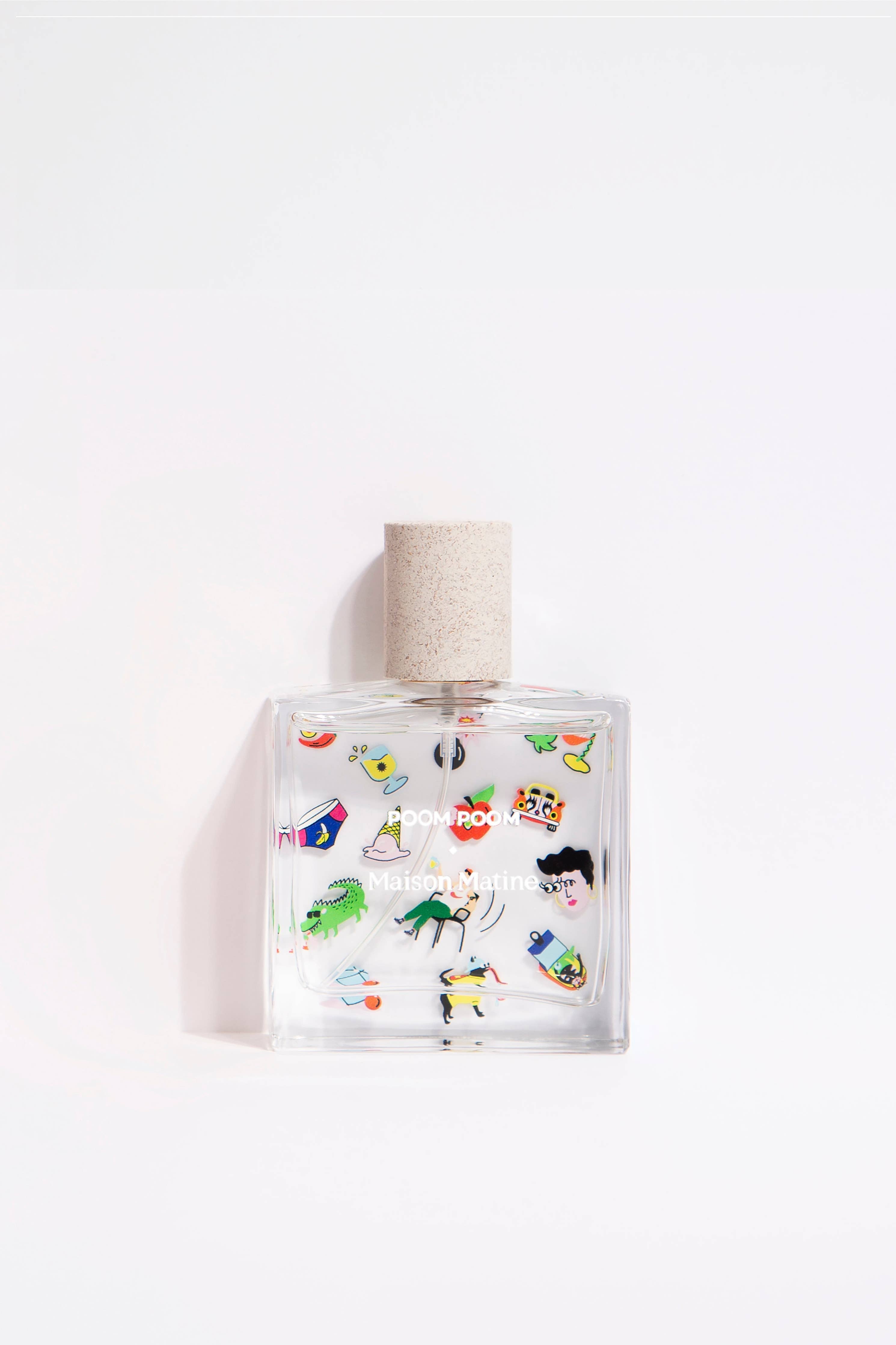 Poom Poom Eau de Parfum bottle with playful illustrations, displayed on an orange and white striped fabric background.
