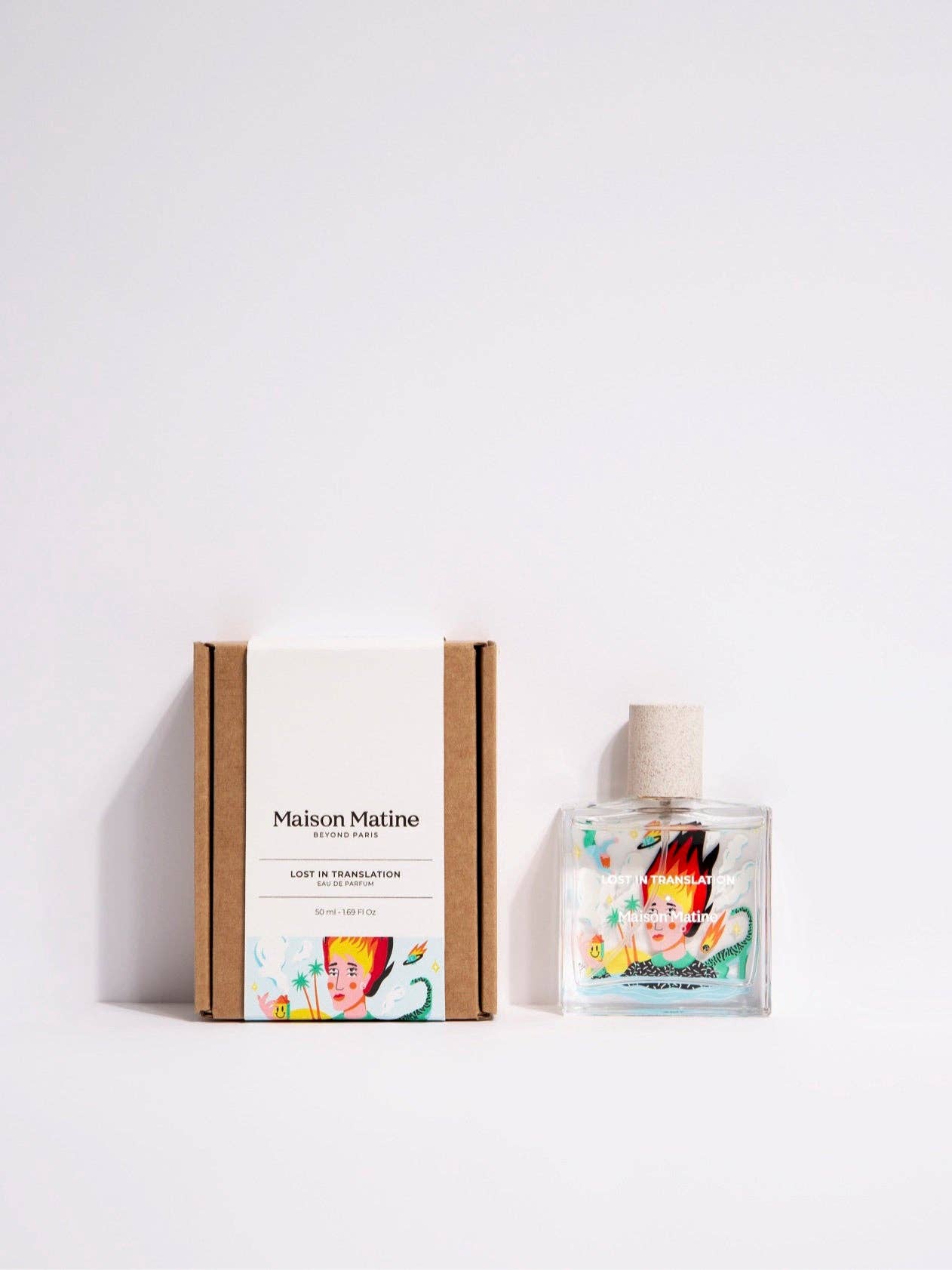 Maison Matine Lost in Translation perfume bottle with bold illustrated design, placed on vibrant yellow textured surface.