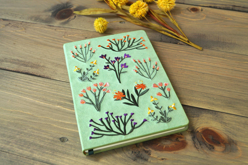 Intricate flower embroidery on a soothing green cover of the Green Flower Embroided Notebook.