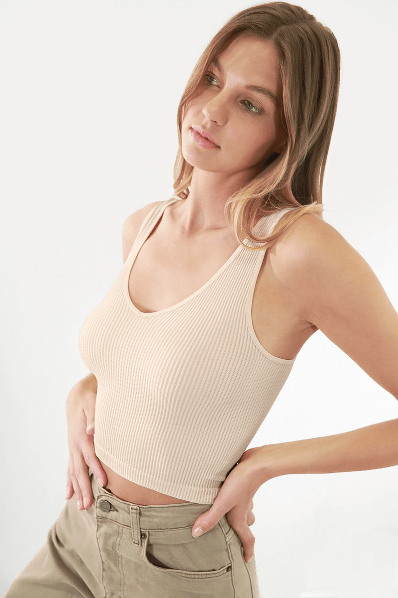 Fashion-forward woman wearing FORMA's Victoria V Neck Ribbed Crop Top, showcasing its flattering design and snug fit.