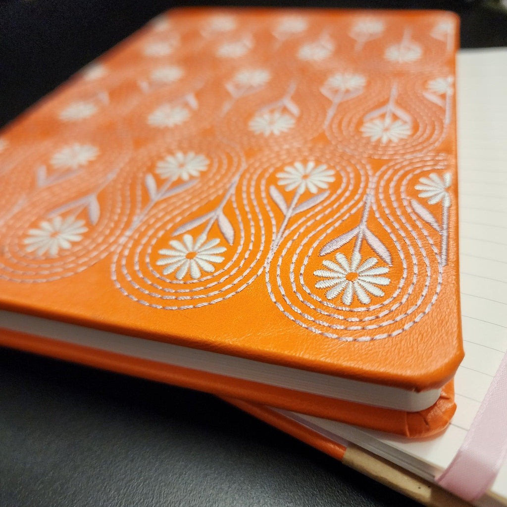 Close up of a Flower Embroided Notebook with intricate floral design on a soft cotton cover.