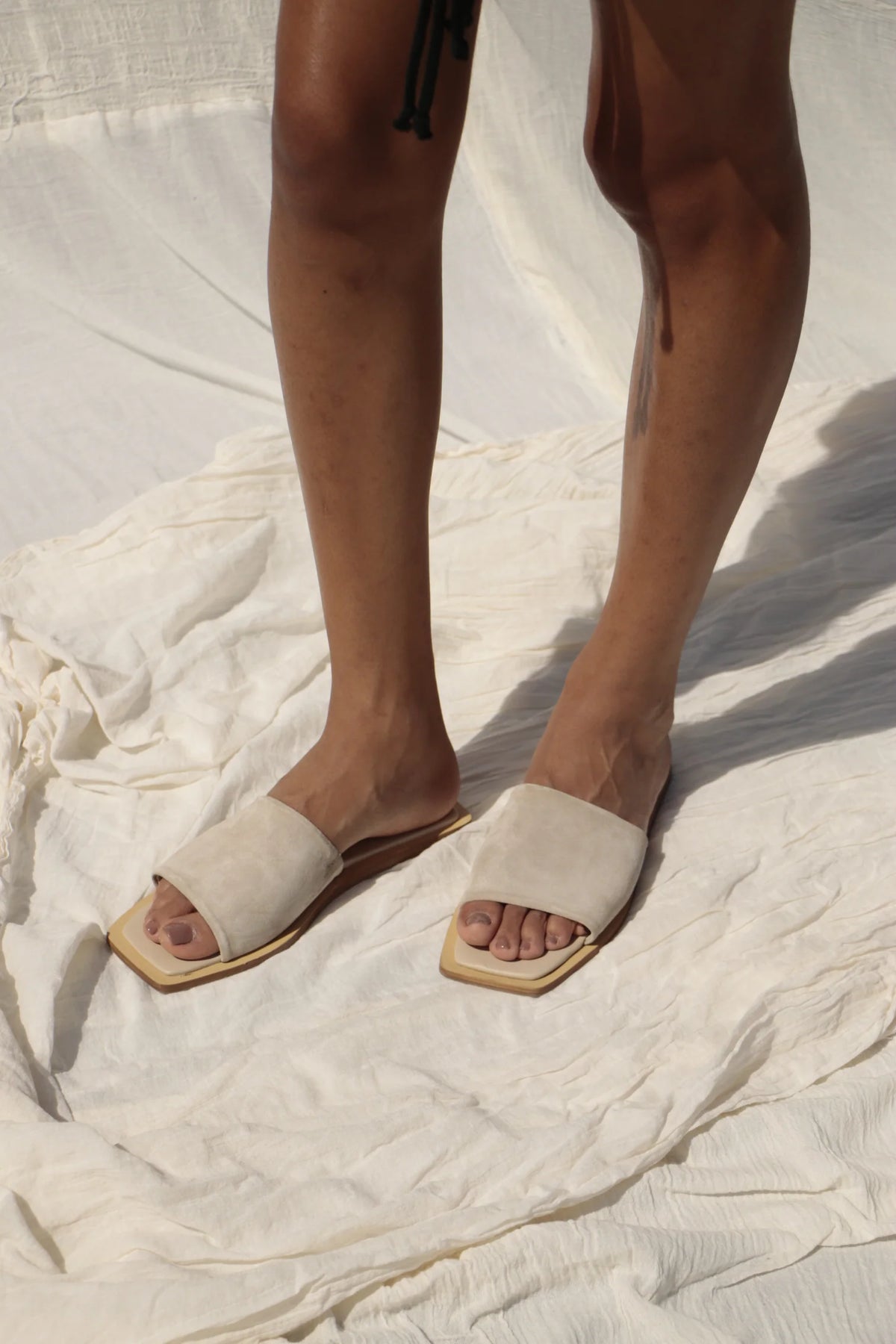 Lenny Sandals displayed in both suede and leather options, showcasing their luxurious materials and classic design.