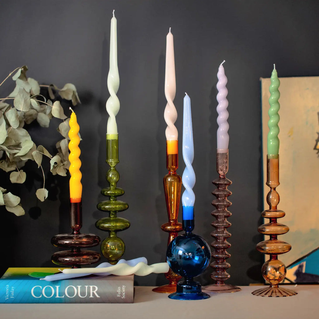 Lilac Spiral Taper Candles, elegantly twisted and emitting a warm glow.