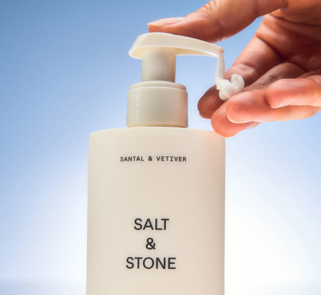 Bottle of Salt & Stone Body Lotion in Santal & Vetiver, a fast-absorbing formula infused with seaweed extracts and niacinamide.