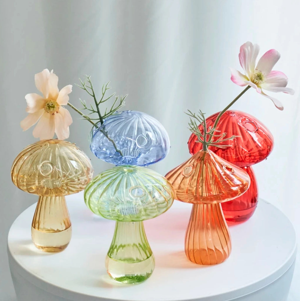 A delightful purple Mushroom Bud Vase made from high-quality borosilicate glass, perfect for displaying favorite flowers.