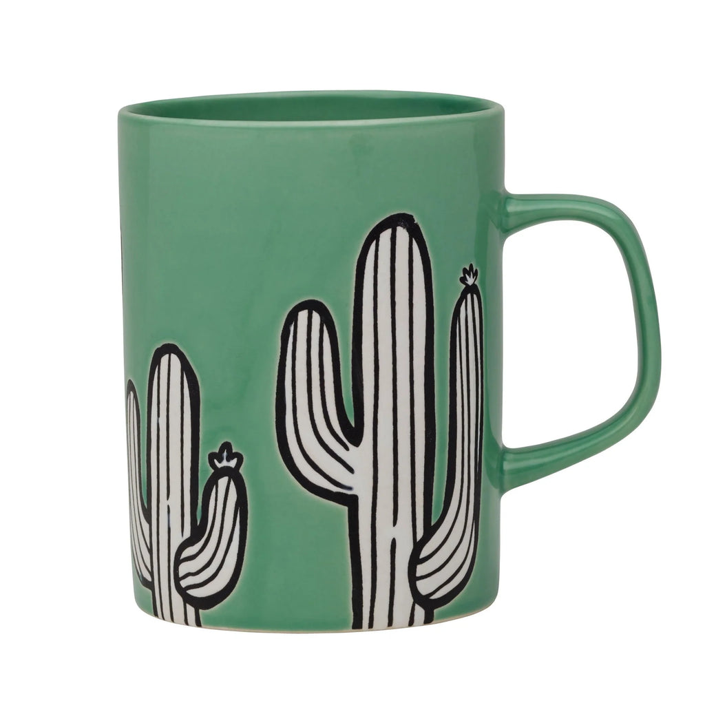 A ceramic mug with a distinctive cactus-inspired design, placed on a kitchen table.