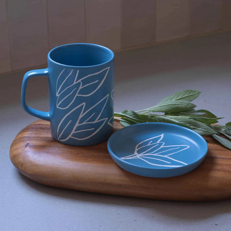 A Ceramic Sage Leaf Mug with a detailed sage leaf pattern, placed on a neutral-toned surface.