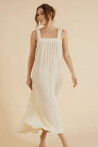 The Noa Straps Maxi Dress, made from 100% Turkish cotton, elegantly displayed, showcasing its delicate straps and flowing maxi length.