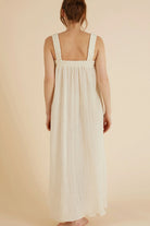 The Noa Straps Maxi Dress, made from 100% Turkish cotton, elegantly displayed, showcasing its delicate straps and flowing maxi length.