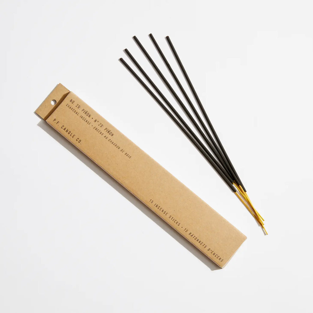 Box of Piñon Incense sticks with a background showcasing the rustic wilderness, reflecting the product's warm, woodsy aroma.