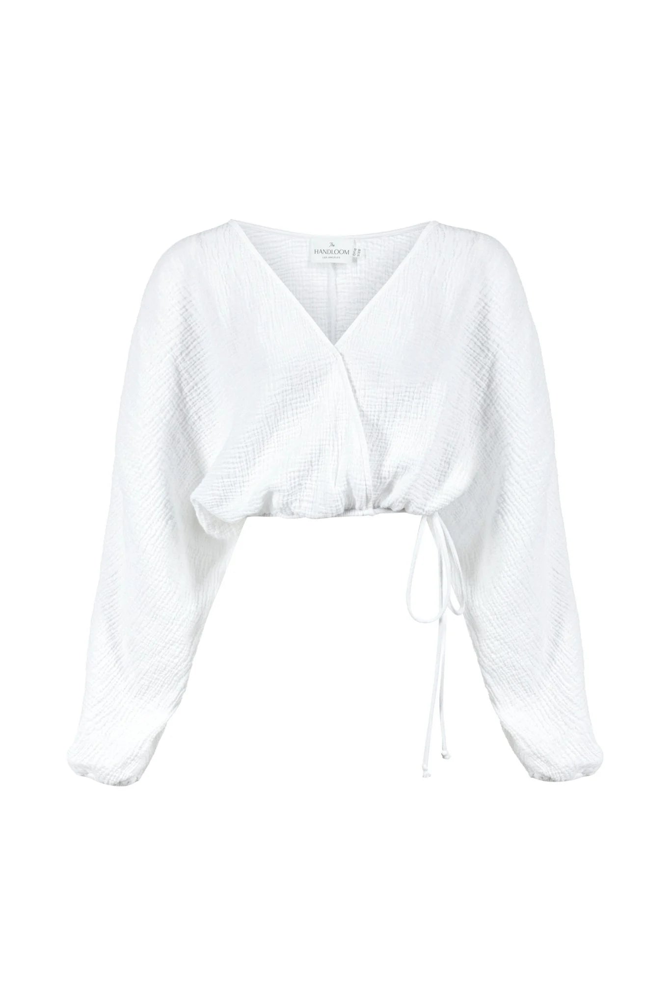 Siena Top displayed on a hanger, showcasing its wide sleeves and the unique V-shaped front drape with a hidden optional closure.