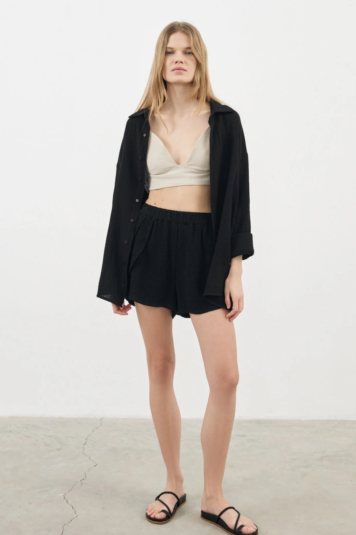 A woman wearing the Sundown Top, showcasing its relaxed fit, short sleeves, and flattering neckline, a versatile and stylish option for any occasion.