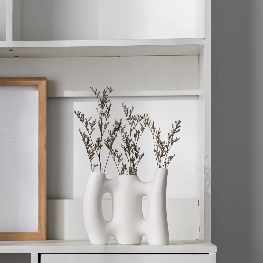 A luxurious white ceramic modern floral vase with a smooth and silky outlook, perfect for adding charm to any room.