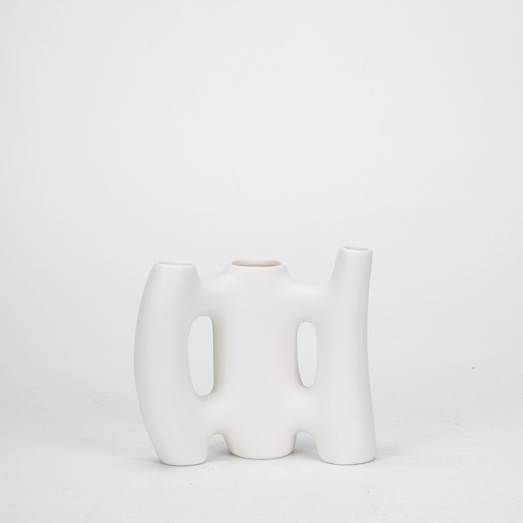 A luxurious white ceramic modern floral vase with a smooth and silky outlook, perfect for adding charm to any room.