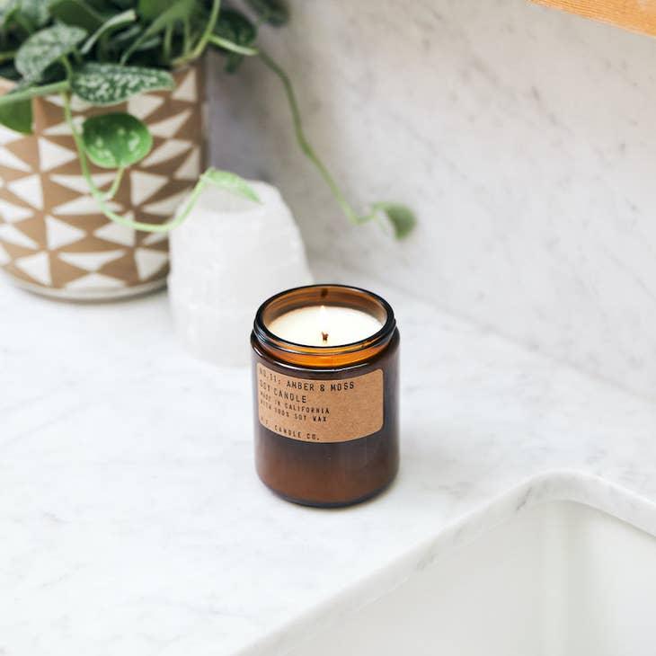Amber & Moss Soy Candle, capturing the earthy essence of nature with its captivating fragrance.