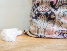 Image of the 'Handmade Printed Persian Cotton Cushion Cover', featuring its soft and fluffy texture, the handmade tassels at each corner, and the intricate printed design.