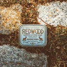 Redwood Incense sticks set against the towering redwoods of California, symbolizing the product's earthy, tranquil fragrance.