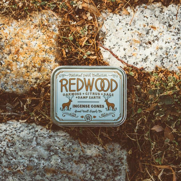 Redwood Incense sticks set against the towering redwoods of California, symbolizing the product's earthy, tranquil fragrance.