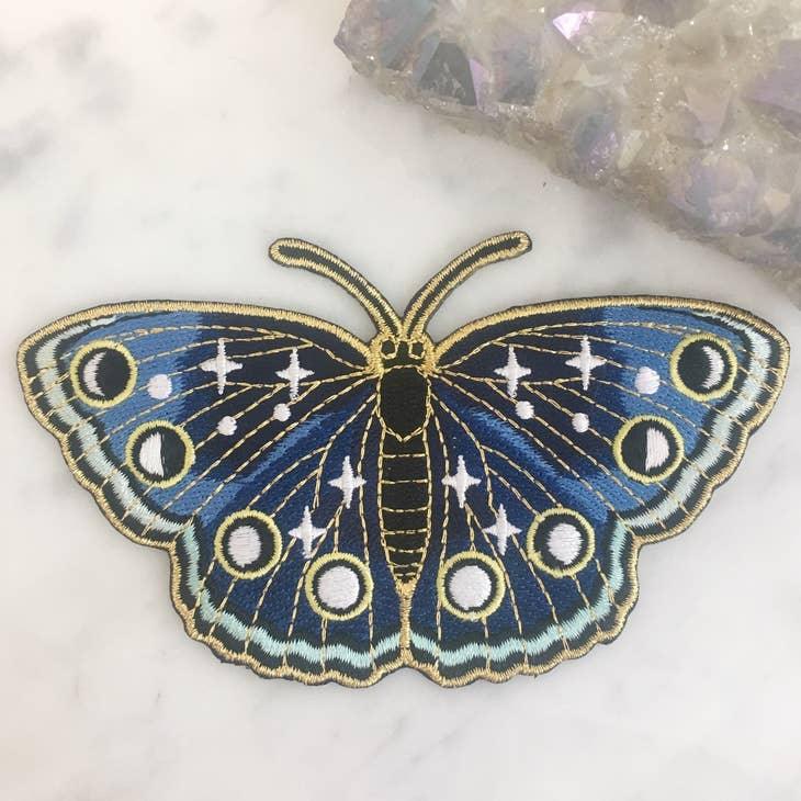 Large embroidered patch showcasing a butterfly in deep navy hues with twinkling star accents.