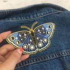 Large embroidered patch showcasing a butterfly in deep navy hues with twinkling star accents.