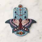 Large embroidered patch displaying a Hamsa integrated with butterfly, evil eyes, crescent moons, arrows, and floral motifs in a vibrant boho color palette.