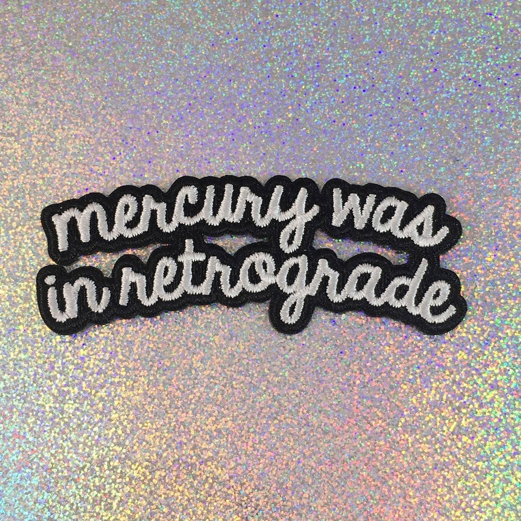 Embroidered patch depicting the planet Mercury with retro styling and text "Was In Retrograde".