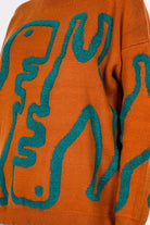 Dinosaur Sweater featuring cute dinosaur motifs on a comfortable, warm fabric, perfect for adding a fun element to your outfit.
