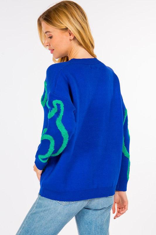Dinosaur Sweater featuring cute dinosaur motifs on a comfortable, warm fabric, perfect for adding a fun element to your outfit.