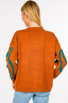 Dinosaur Sweater featuring cute dinosaur motifs on a comfortable, warm fabric, perfect for adding a fun element to your outfit.