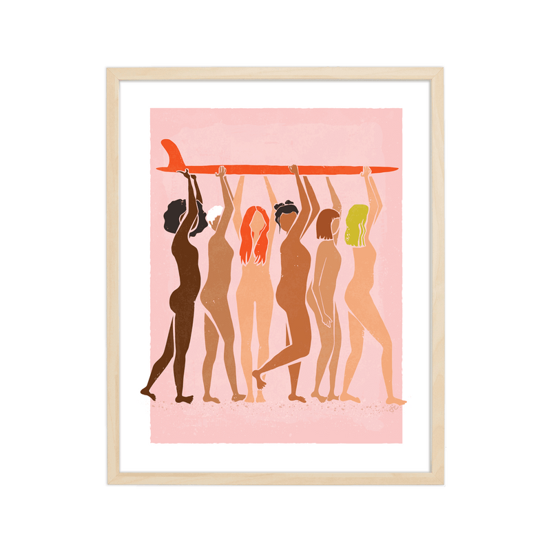 Helping Hands Print featuring diverse women standing together and holding a surfboard, framed in a wooden frame.