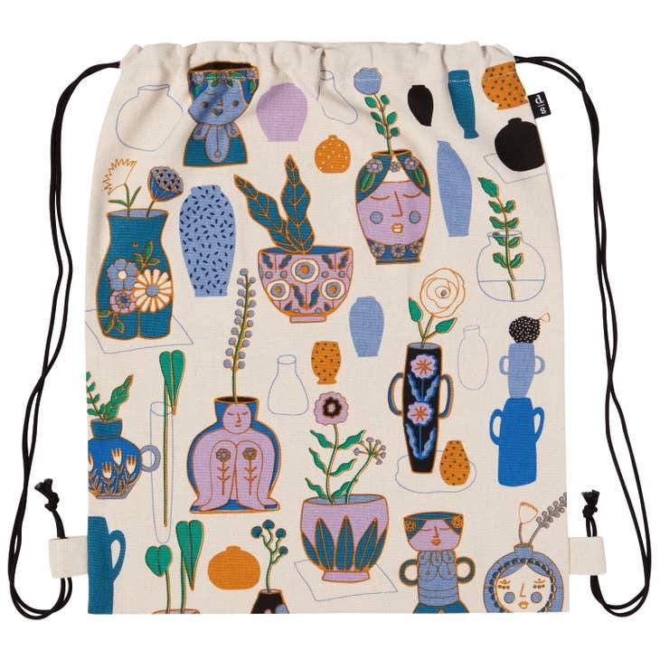 Still Life Cinch Backpack - Modern drawstring bag featuring a contrasting palette of blue, mauve, and green on a white background.