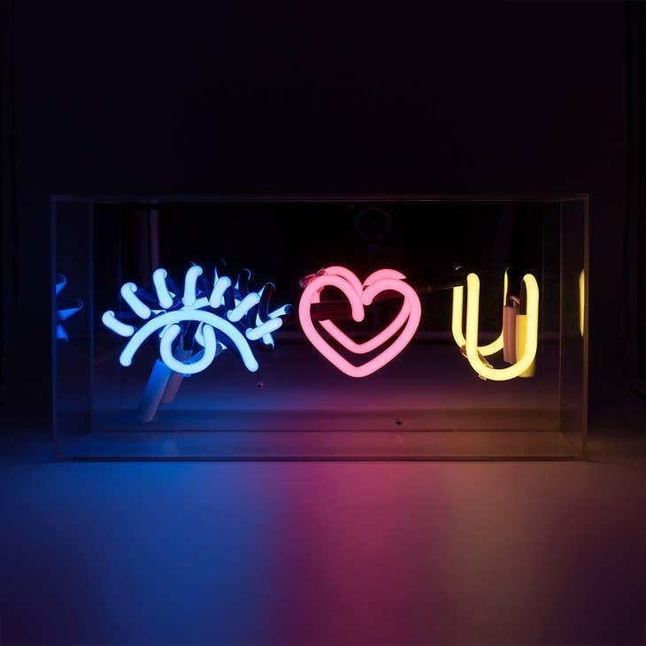 FORMA's Neon "Eye Love You" Lights in blue, red, and yellow, illuminating an affectionate message in a stylish way.