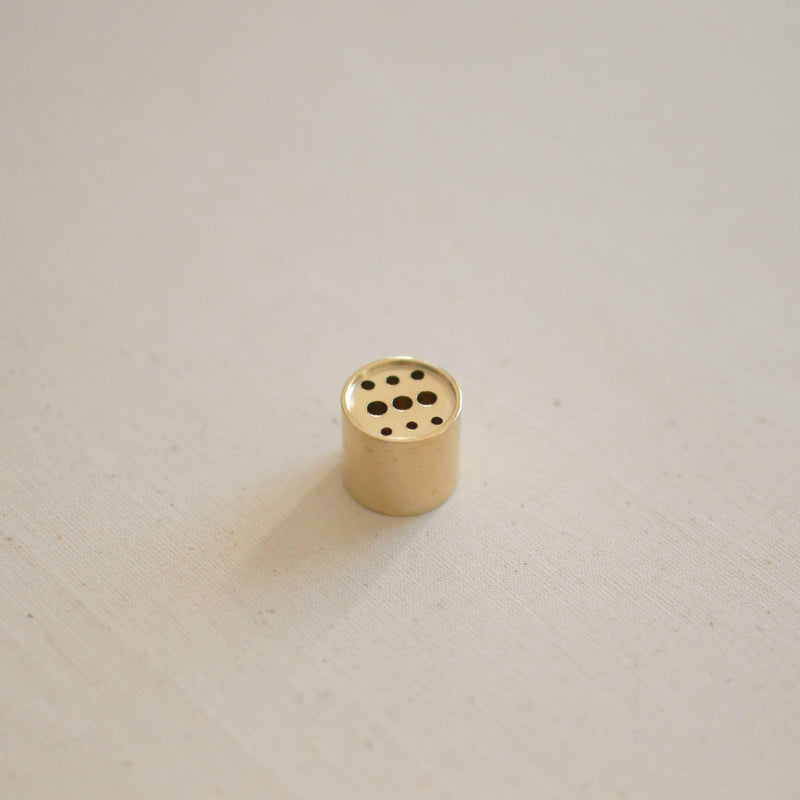 Polished Brass Round Incense Holder with a minimalist design, placed on a serene backdrop, perfect for holding your favorite incense.